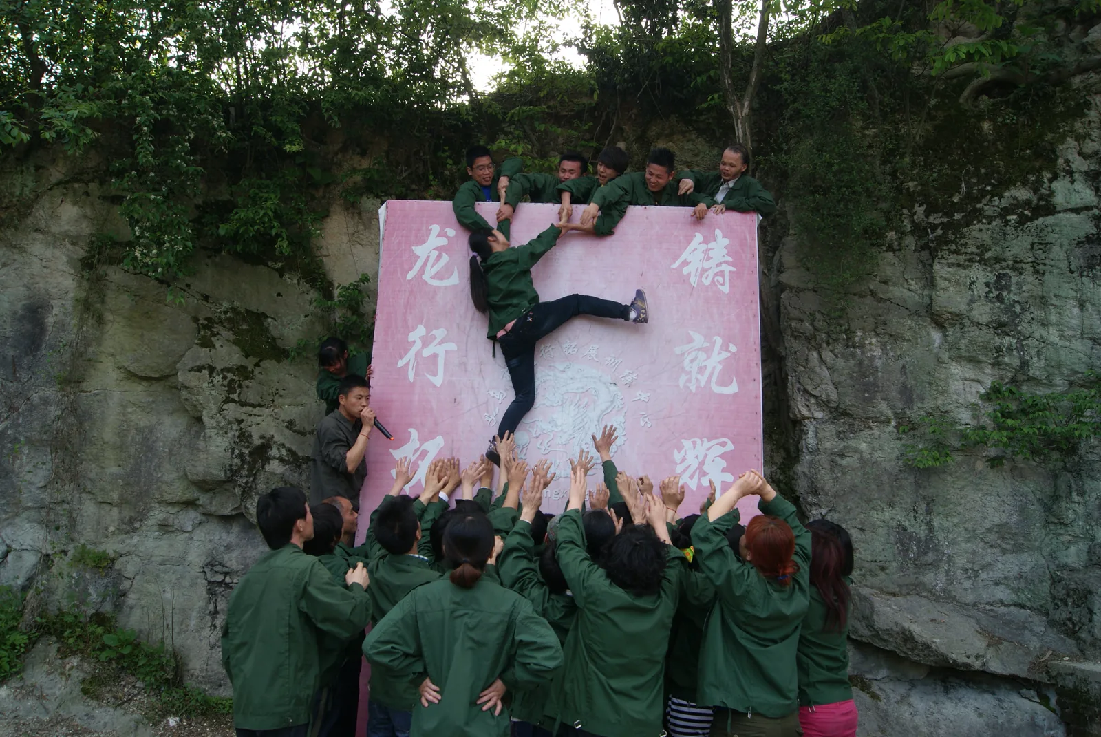 ARIS team helping each other during an outdoor team-building challenge